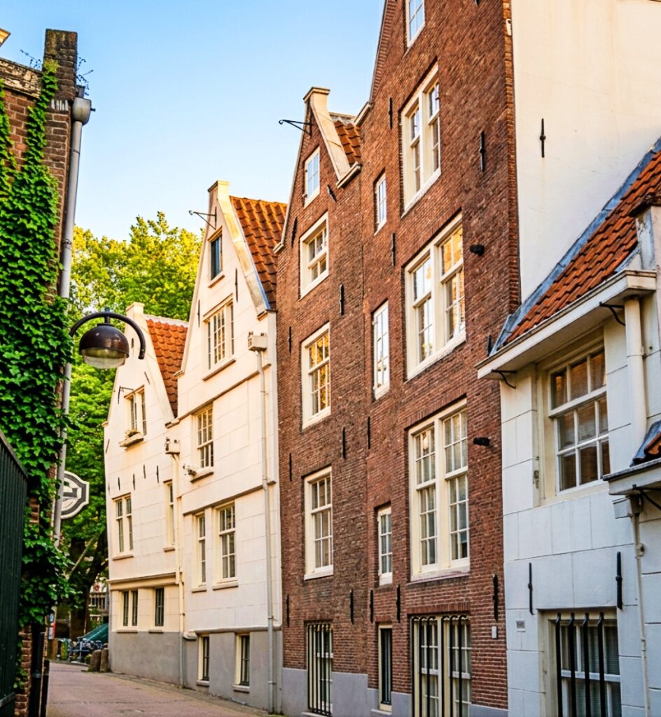 A scenic street in Amsterdam with gabled houses.